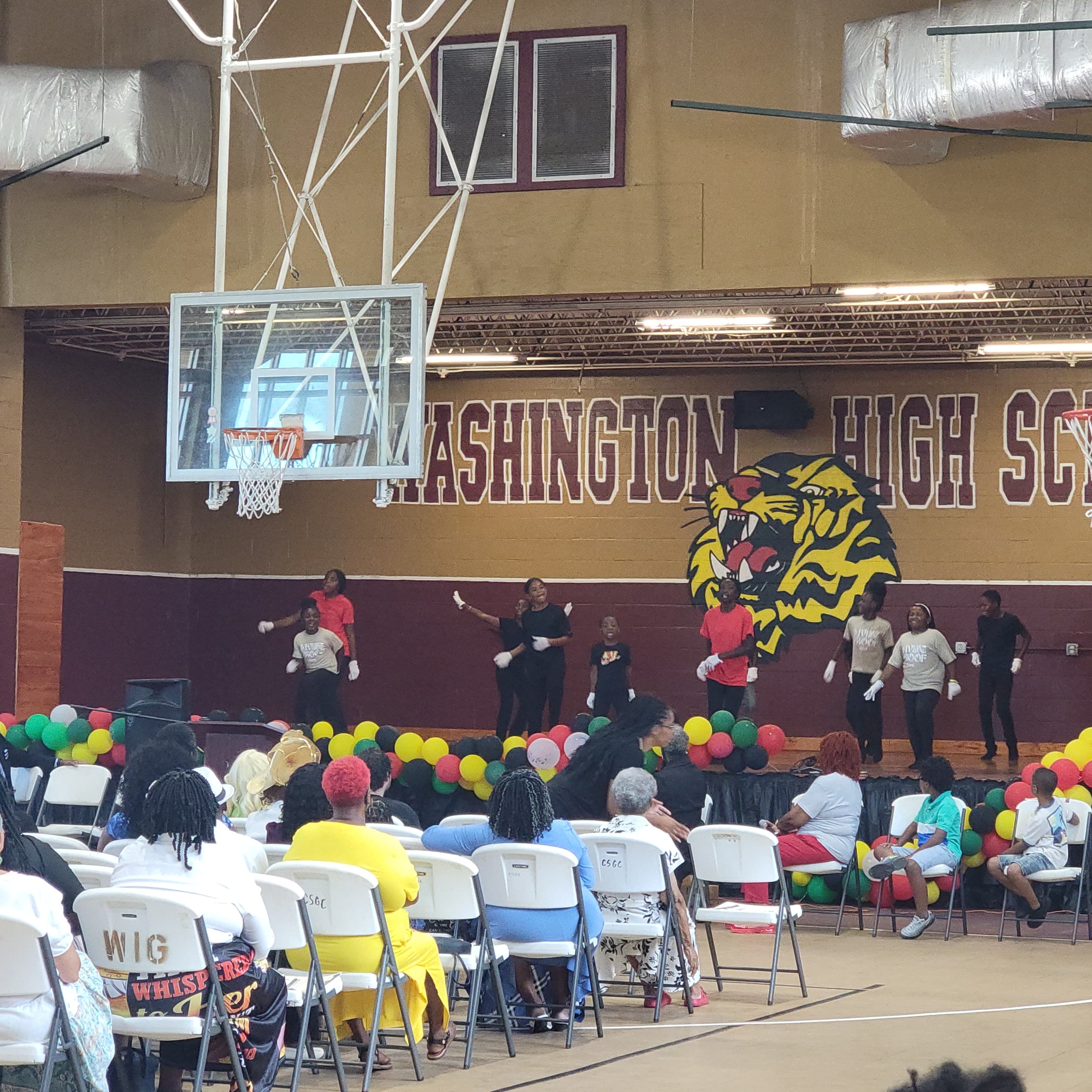 Performers dancing at the Juneteenth ceremony at Washington High School