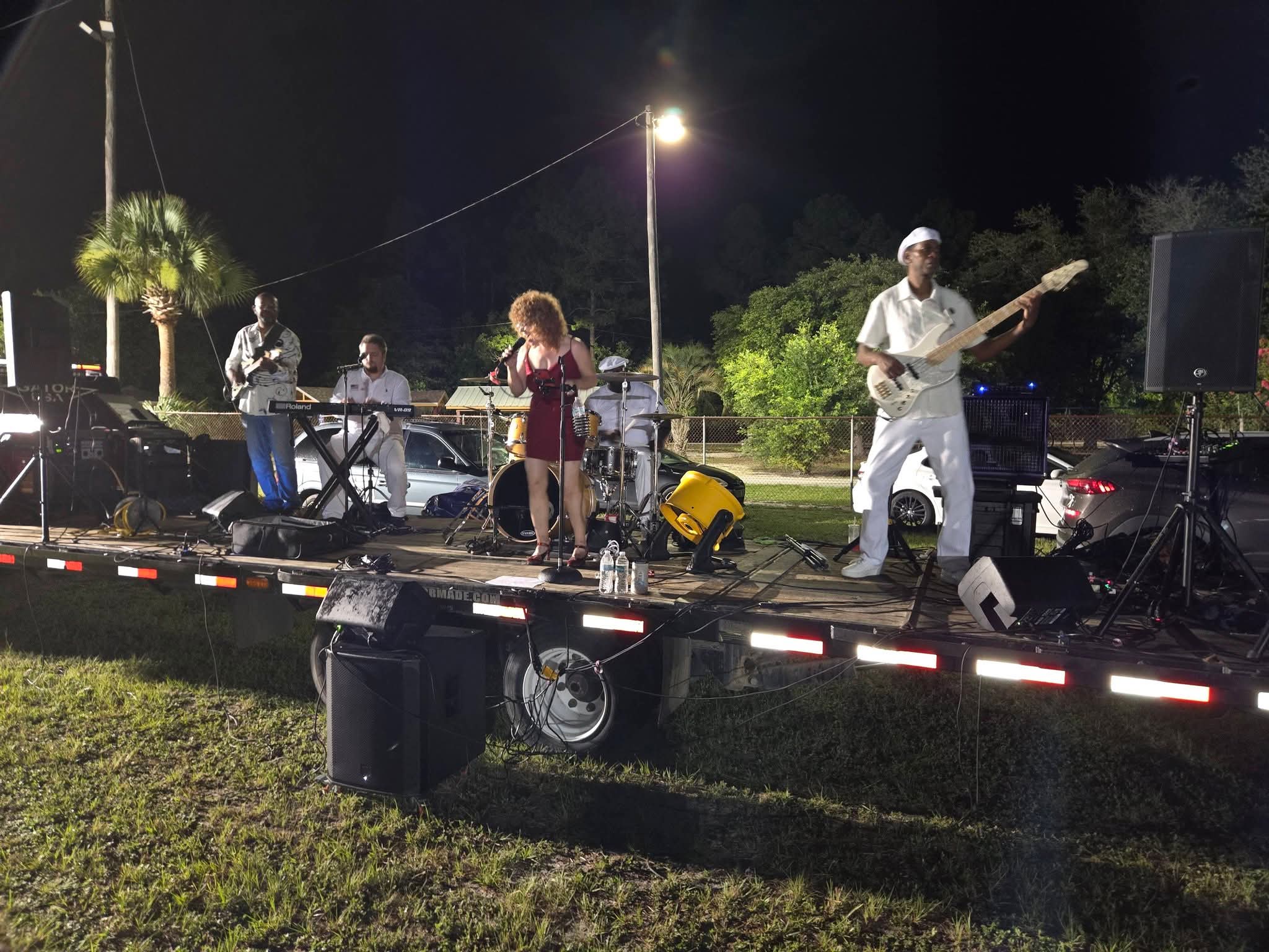 Live band performing on stage at the Juneteenth evening concert
