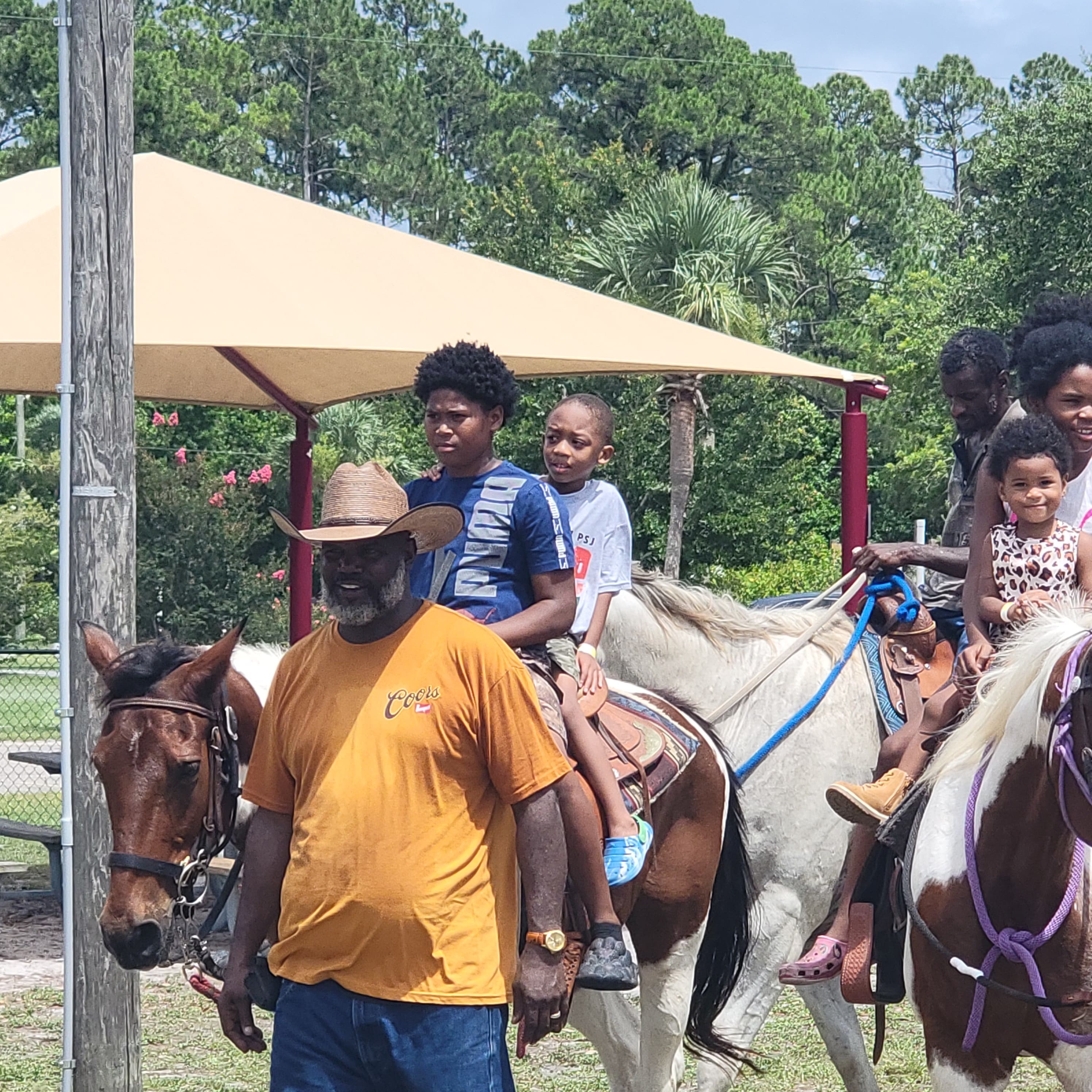 Family with child on horseback at the Juneteenth celebration