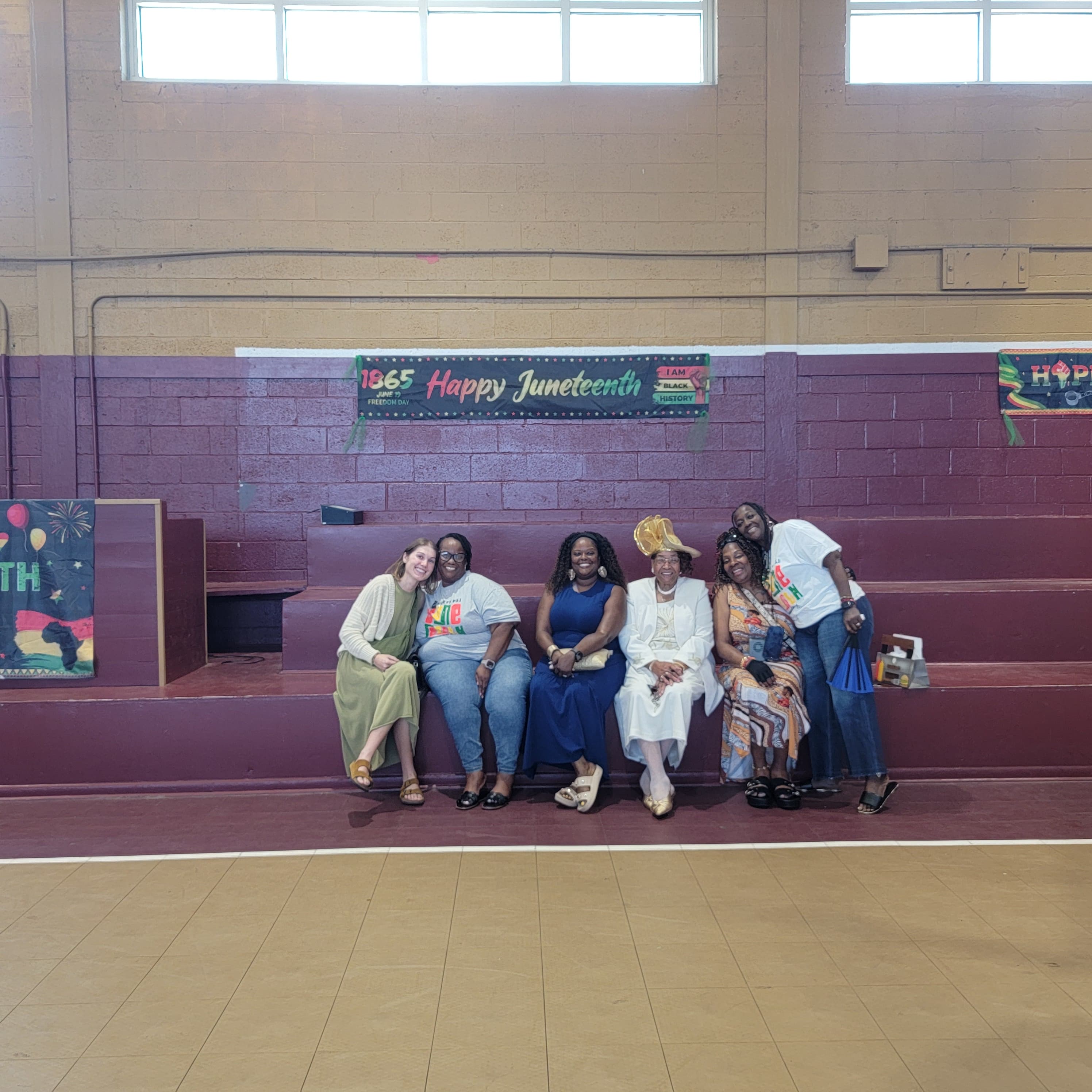 Group portrait in front of the Happy Juneteenth banner at Washington High School