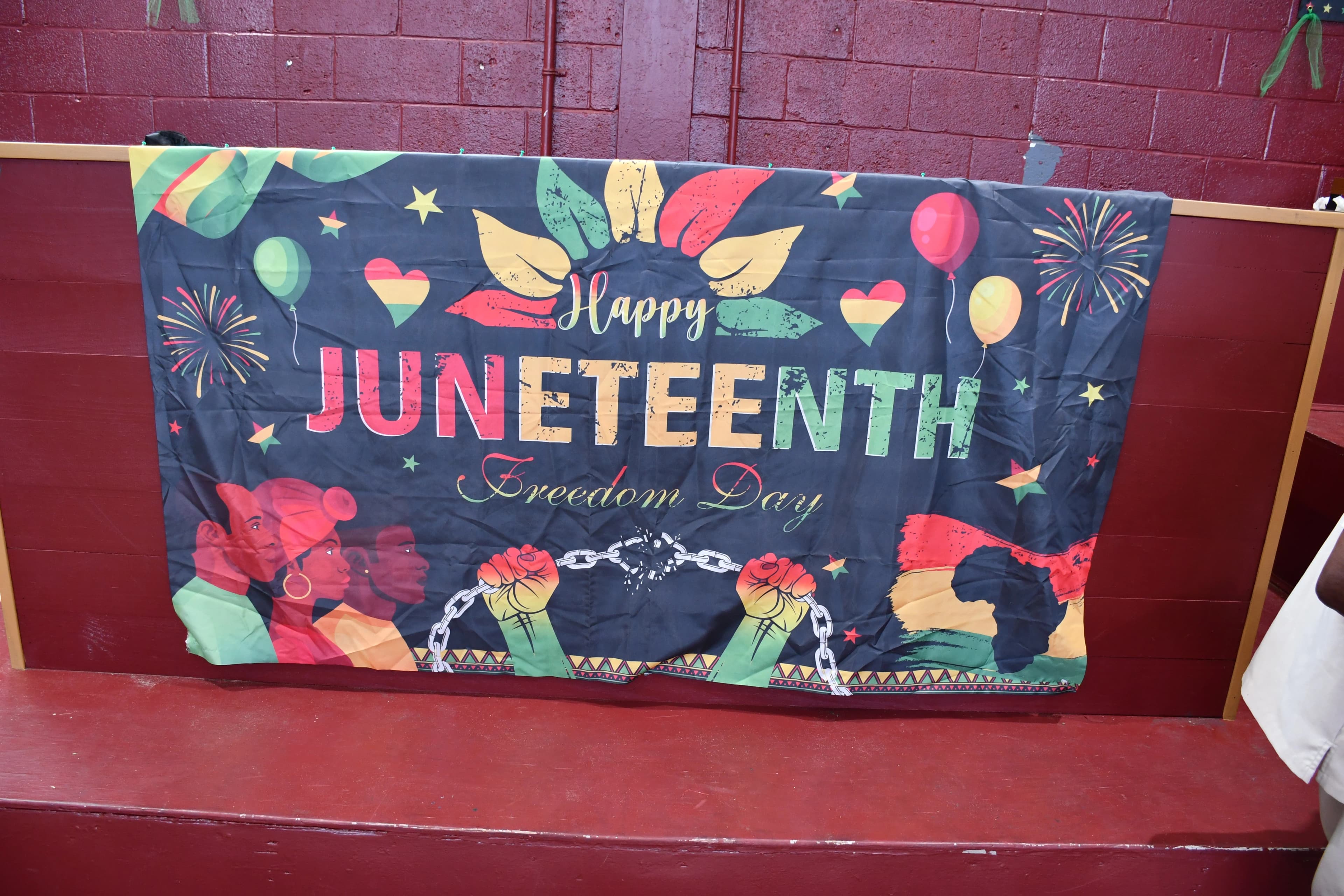 Happy Juneteenth Freedom Day banner draped across the bleachers at Washington High School