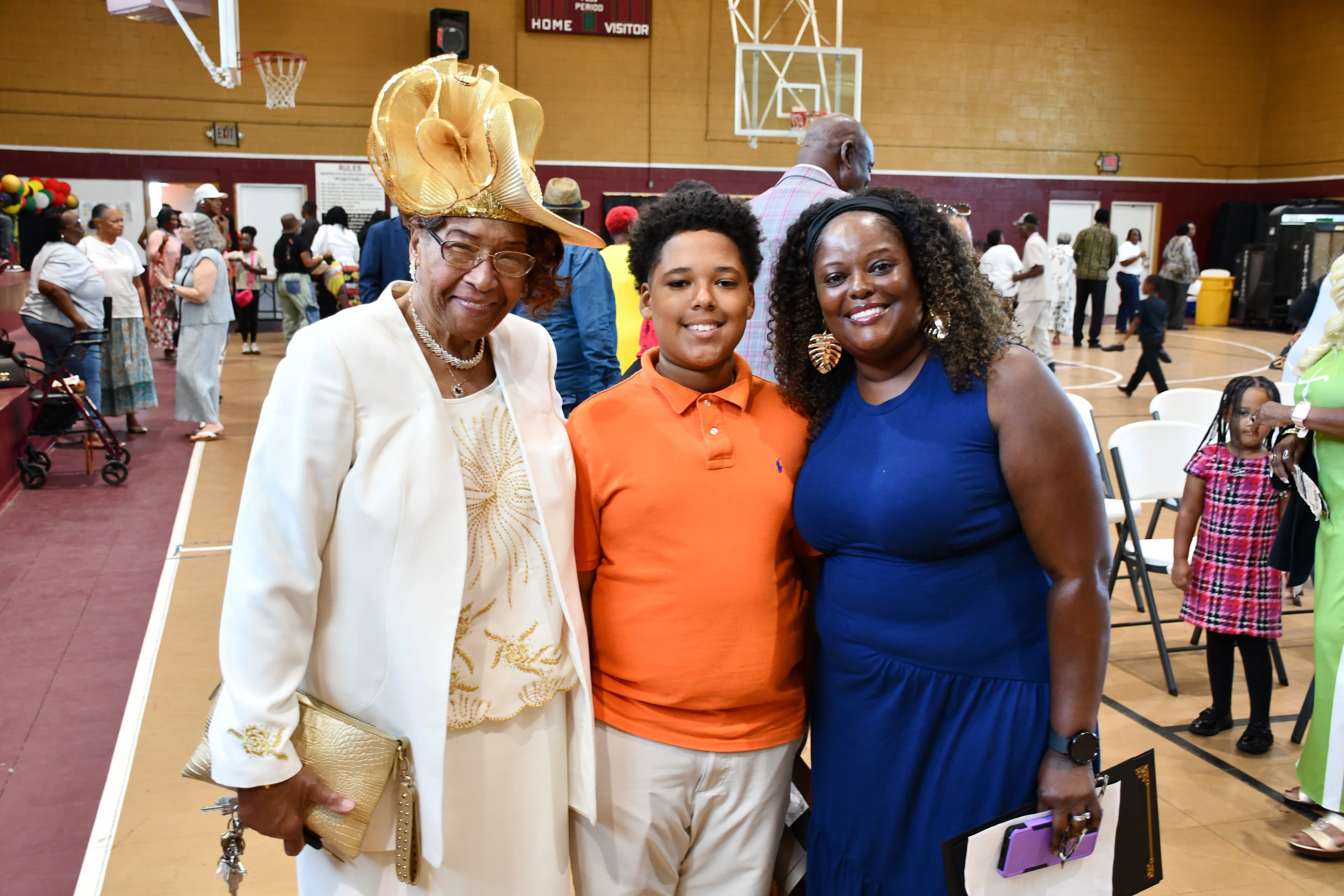 Three generations of family posing together at the Juneteenth celebration