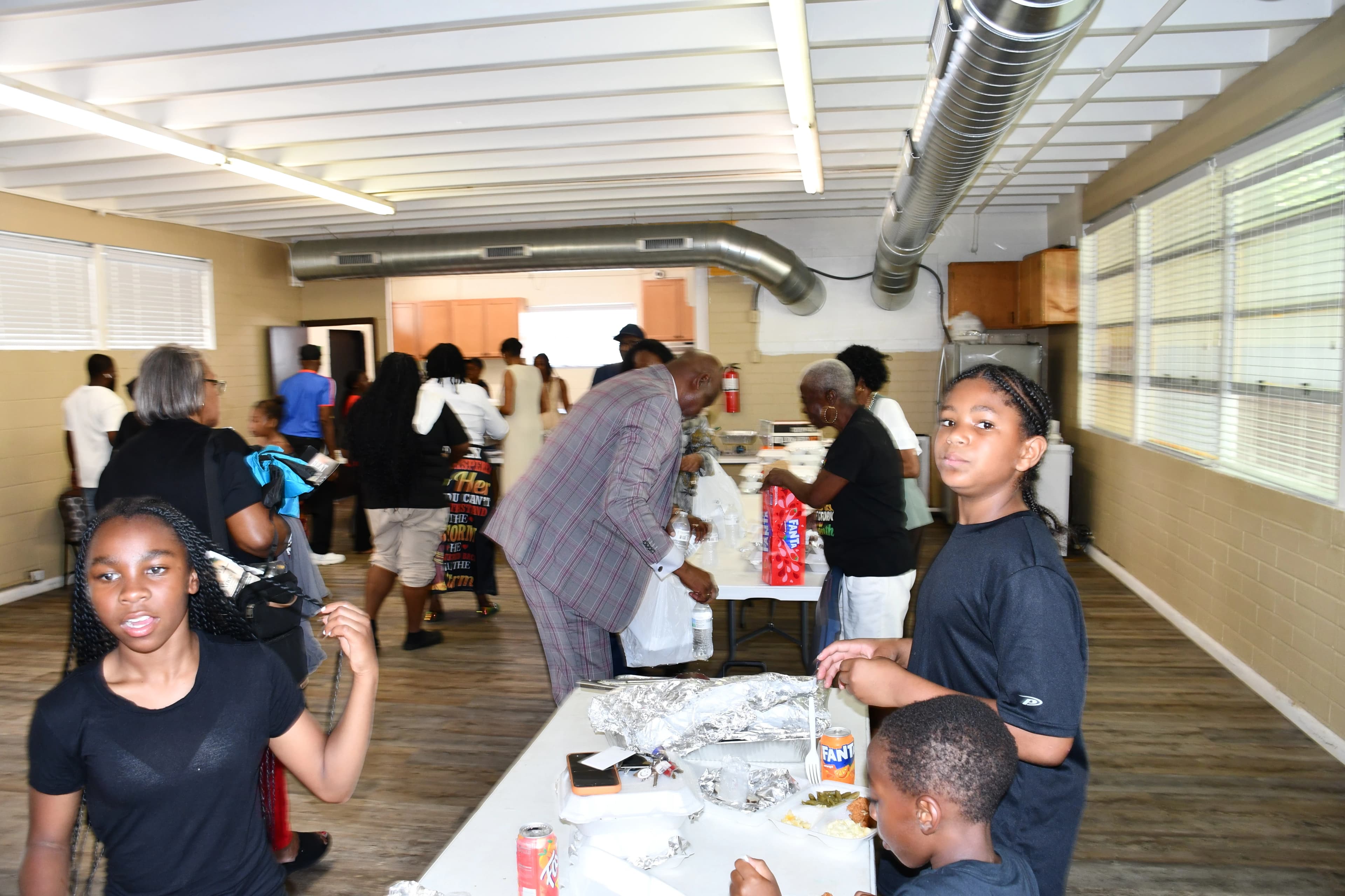 Community members gathering for food and fellowship after the Juneteenth ceremony