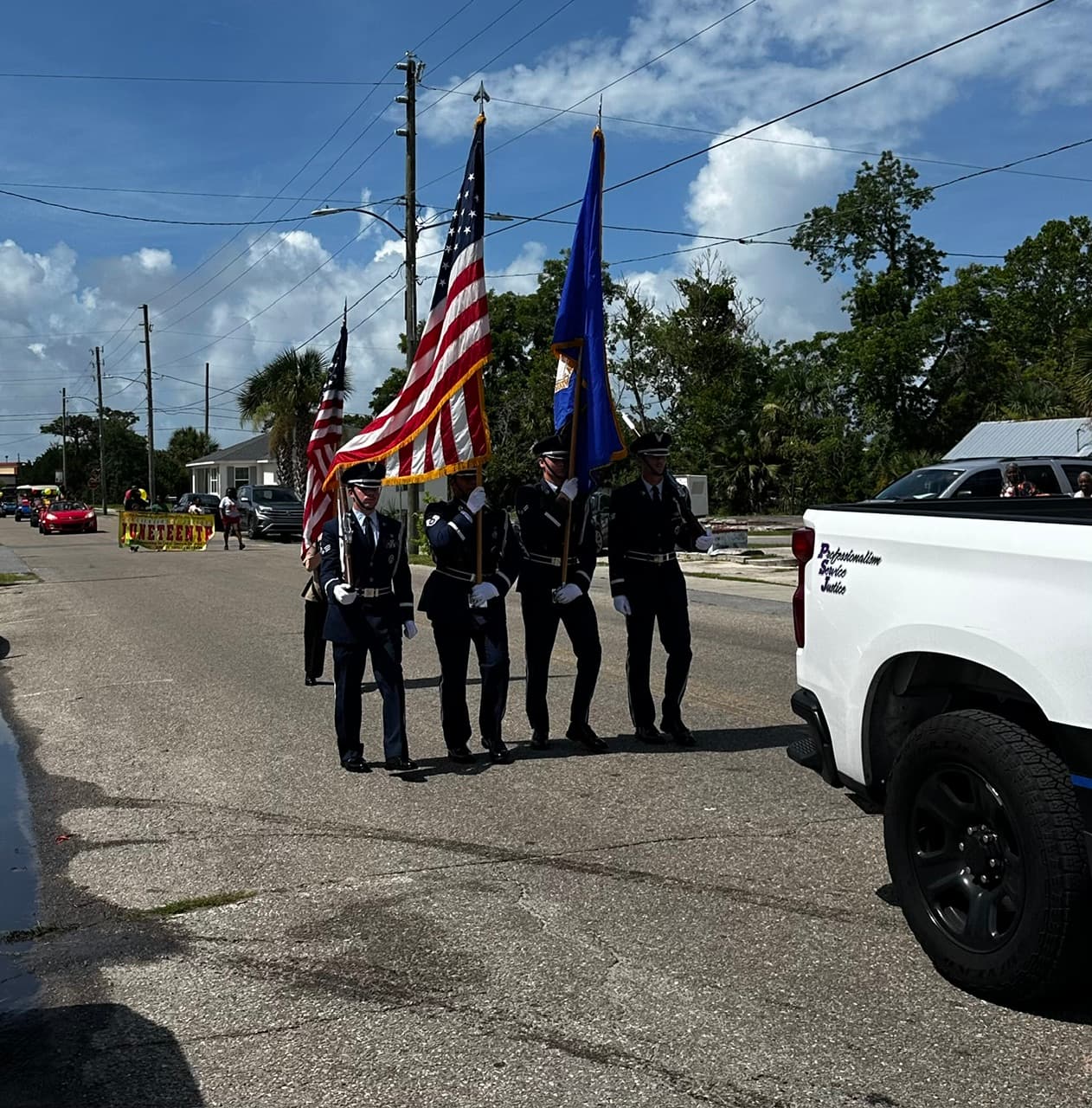 Military color guard carrying American and Florida flags in the Juneteenth parade in North Port St. Joe