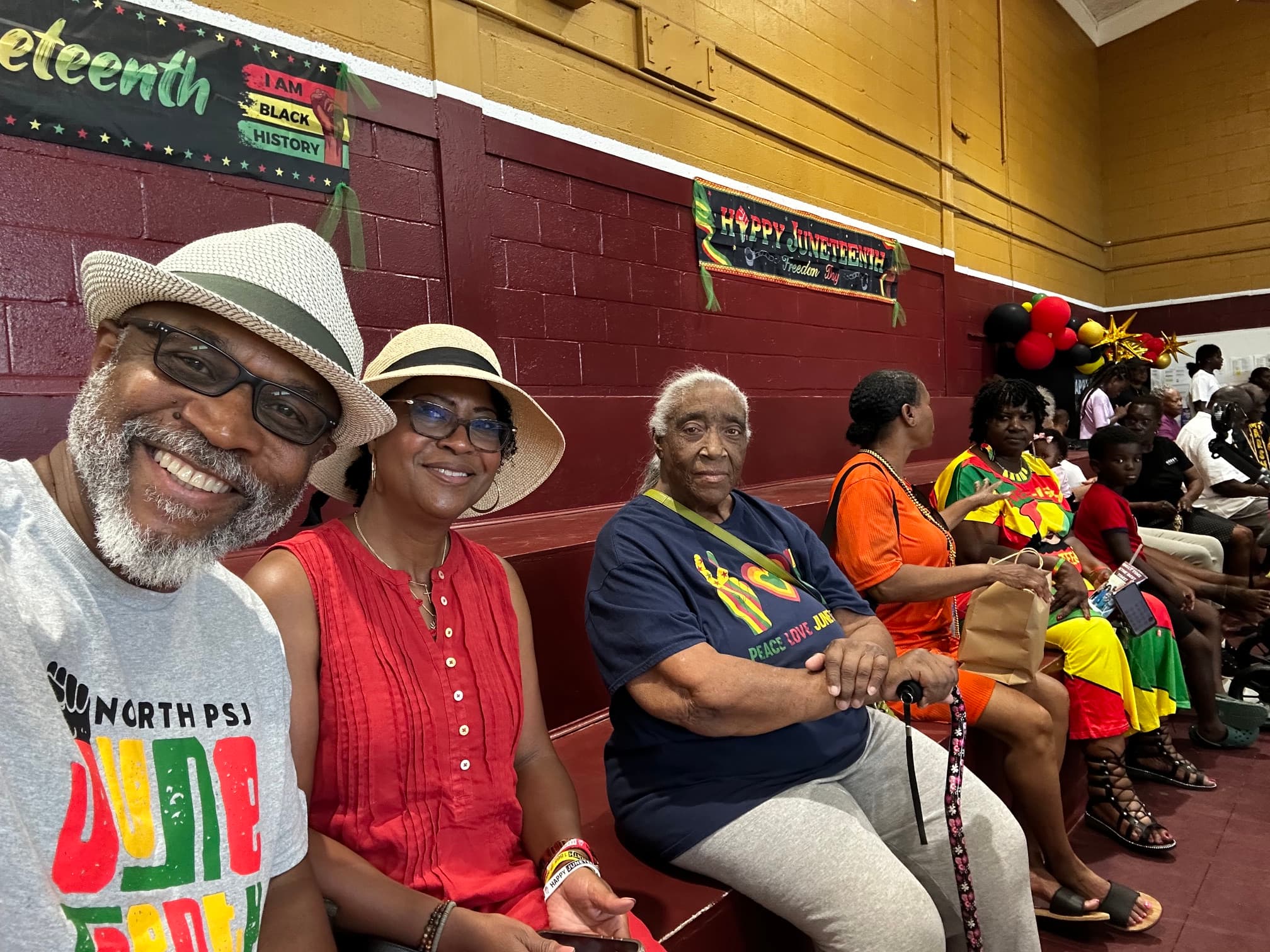 Community members enjoying the indoor Juneteenth celebration at Washington High School